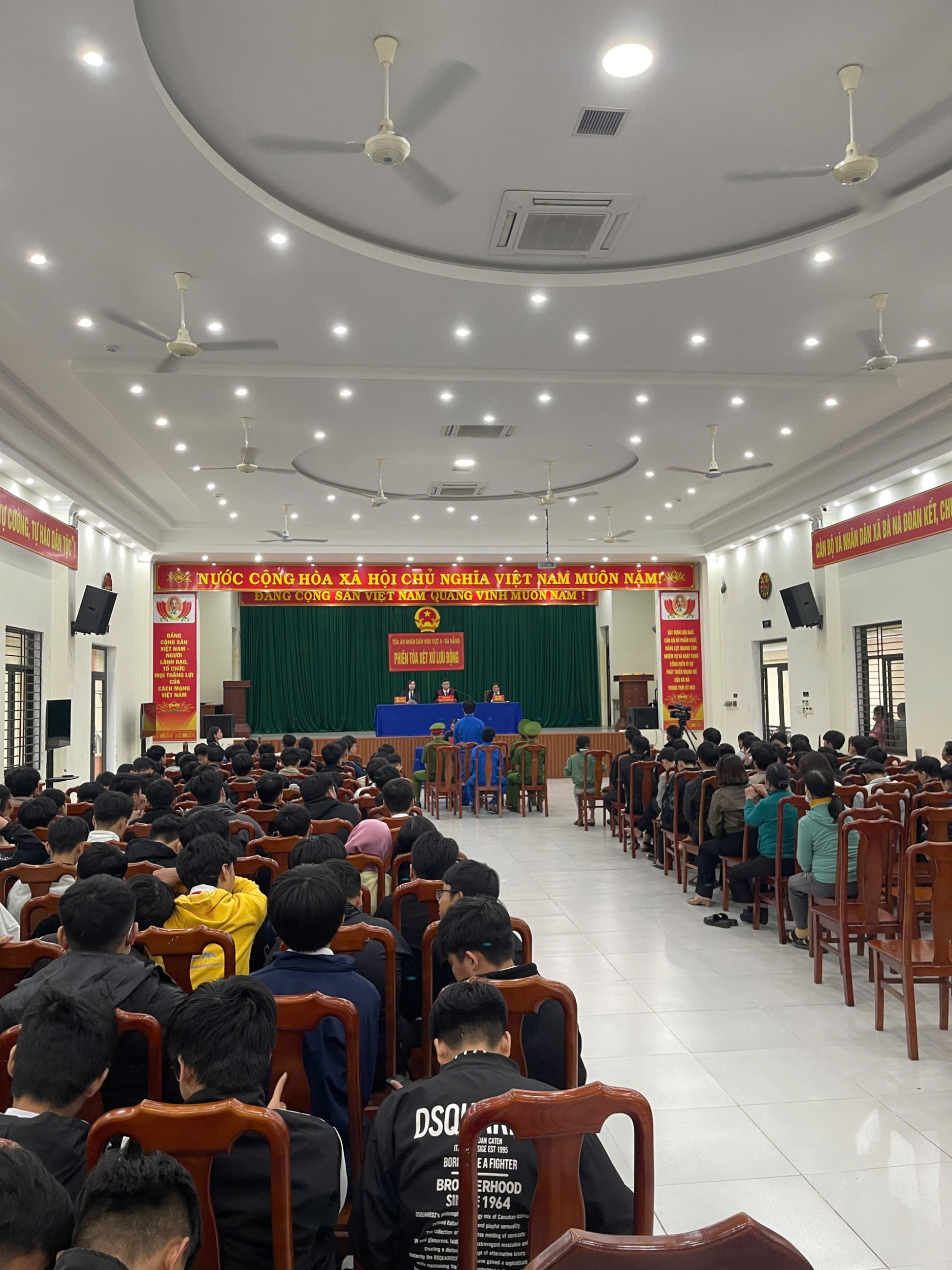 '''A group of people sitting in chairs in a room with a person on a podium
AI-generated content may be incorrect.'''