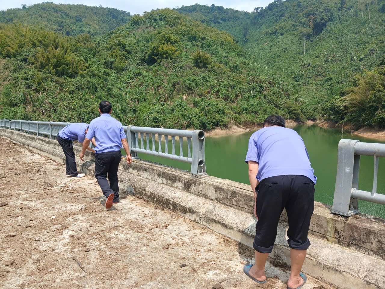 ''''A group of men standing on a bridge over a river

AI-generated content may be incorrect.''''