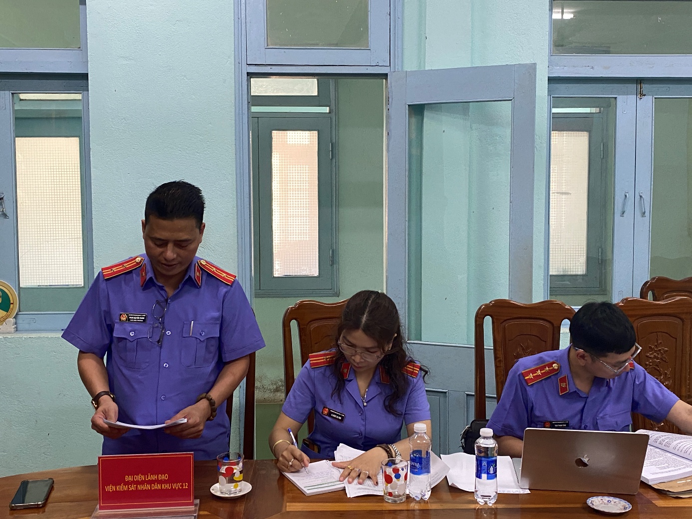 ''''A group of people in uniform sitting at a table

AI-generated content may be incorrect.''''